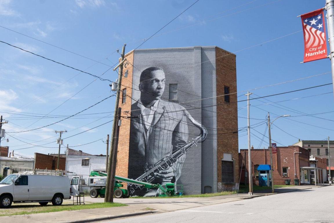 wide-shot of mural of John Coltrane in Hamlet, NC