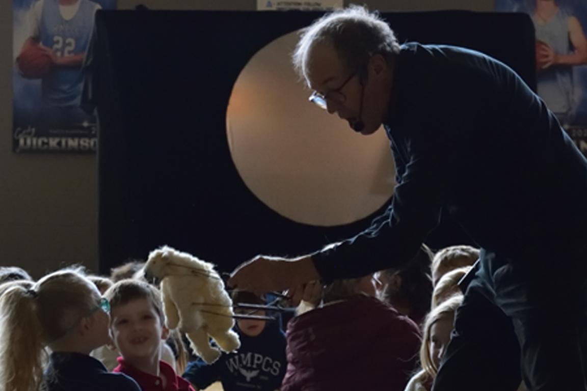 Master Puppeteer Hobey Ford entertains young students at Washington Montessori Public Charter School with an animal puppet. Photo by Izzy Harris, courtesy of Washington Montessori Public Charter School. 