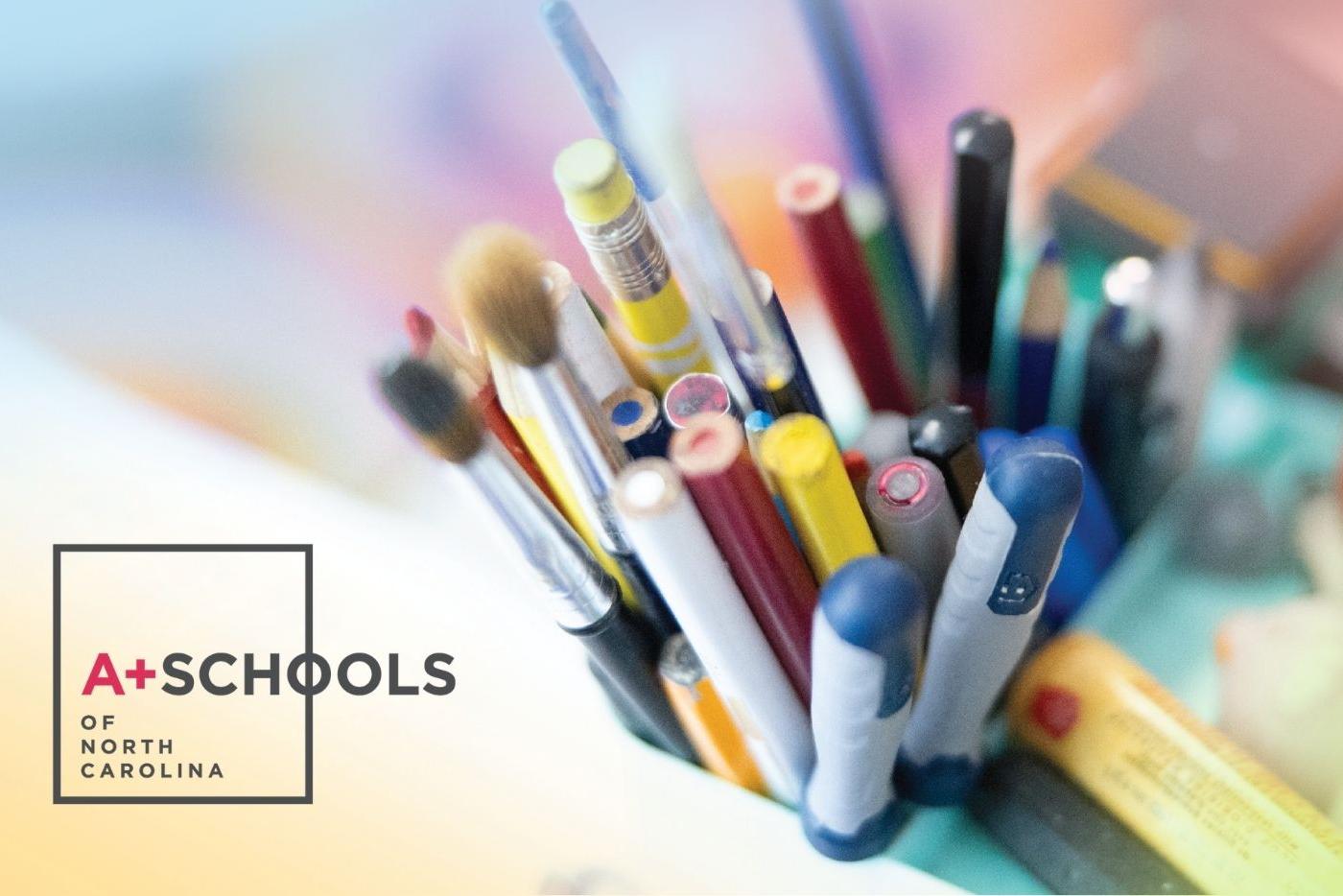 A+ Schools of NC logo on a background image of a container with pens, pencils, and brushes