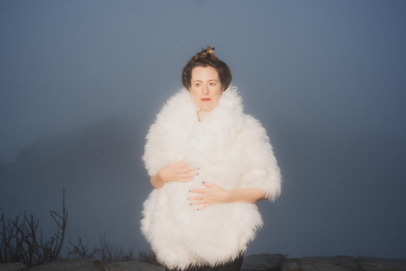 Skylar Gudasz stands for a portrait in a foggy scene