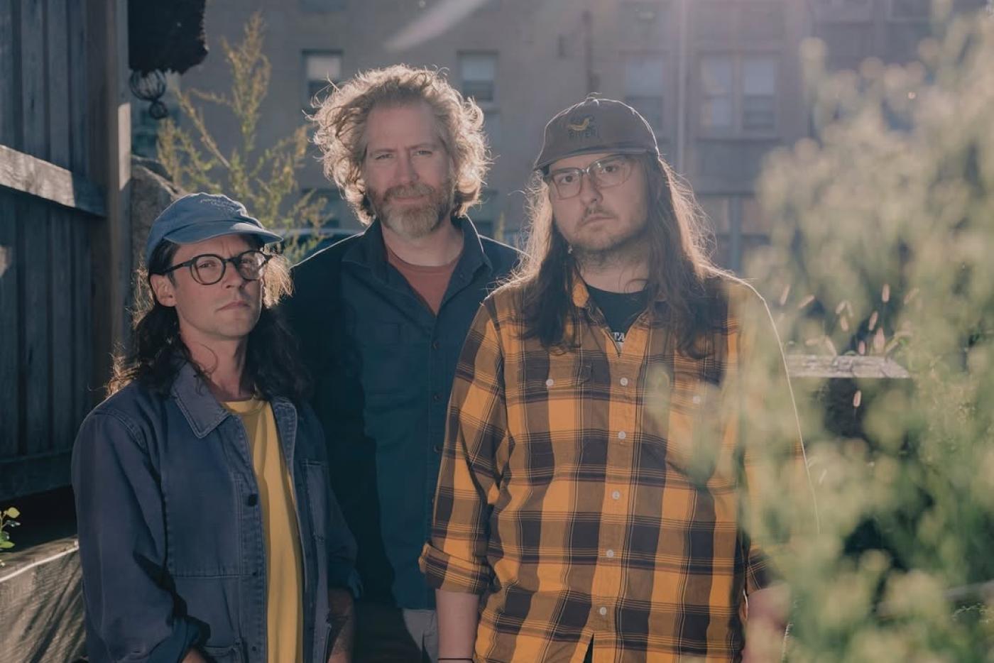 the band Setting, a three-piece, pose for an outdoor portriat 