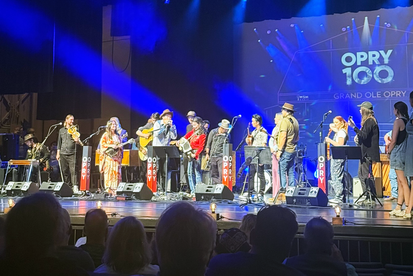a gaggle of musicians perform at Merlefest on OPRY 100 stage