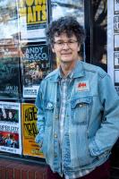 David Menconi standing in a denim jacket