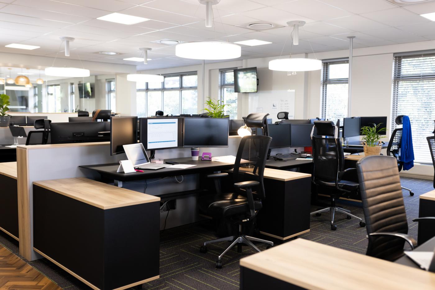 Empty open space office with desks, chairs and computers