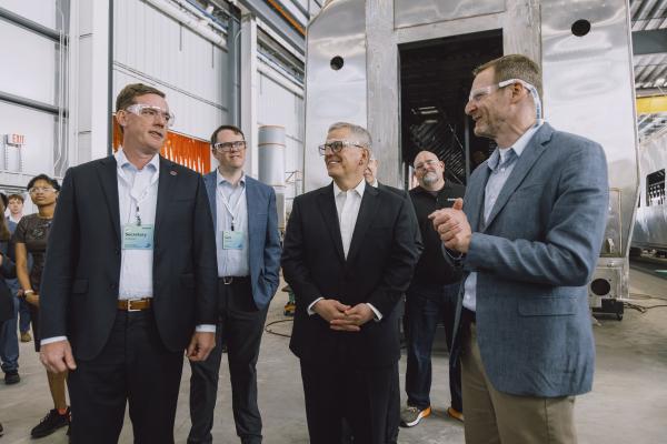 Governor Stein listens to Siemens leadership talk about the new passenger train manufacturing center during a tour