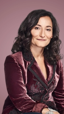 woman with dark hair in a business suit