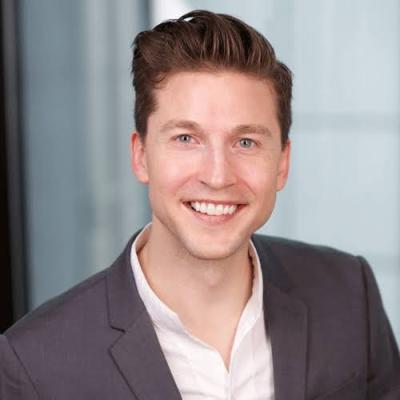 man with dark hair in business casual attire