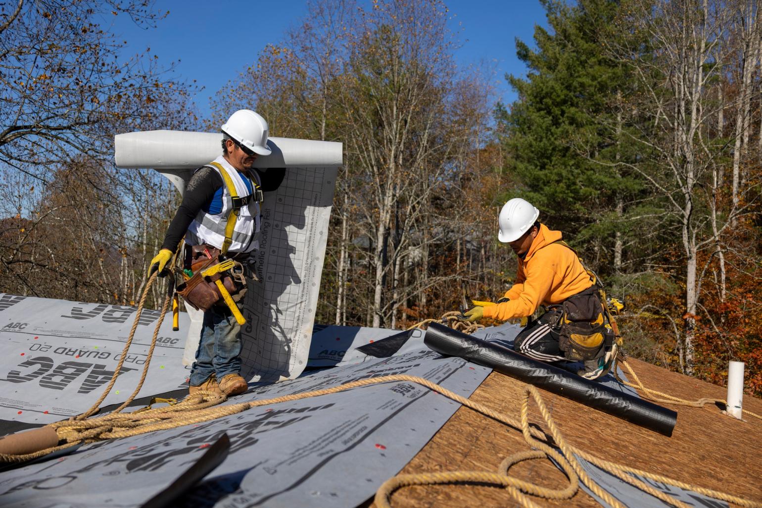 construction workers repairing rooftop