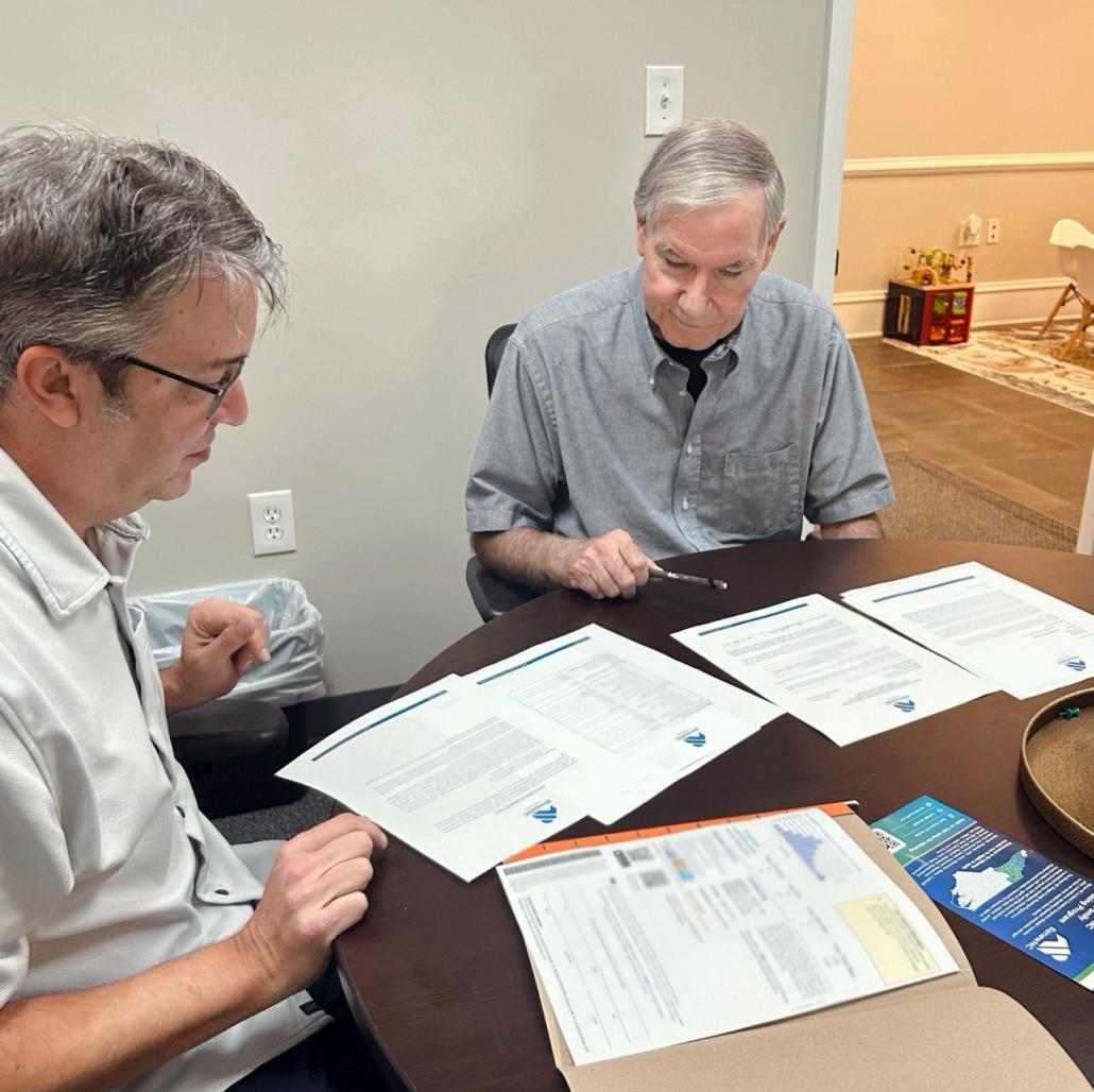 homeowner signs Renew NC grant agreement