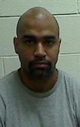 Brandon James Lee, balding Black man, prison photo.