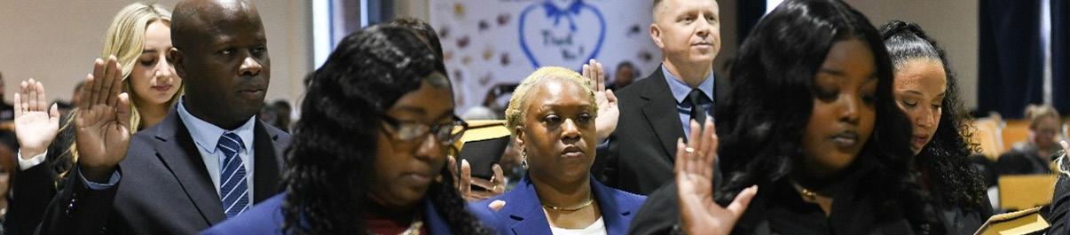 New employees taking an oath during swearing-in ceremony
