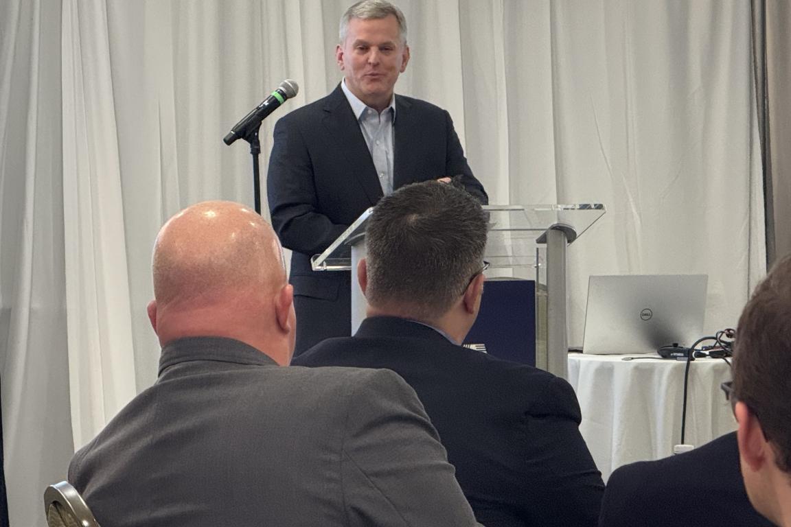 Gov stein at front of room speaking to group in ballroom