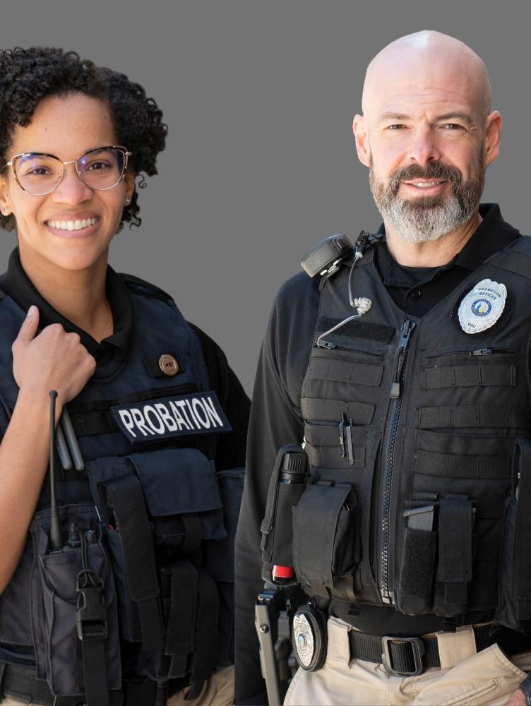 a black woman and white man in PPO uniforms