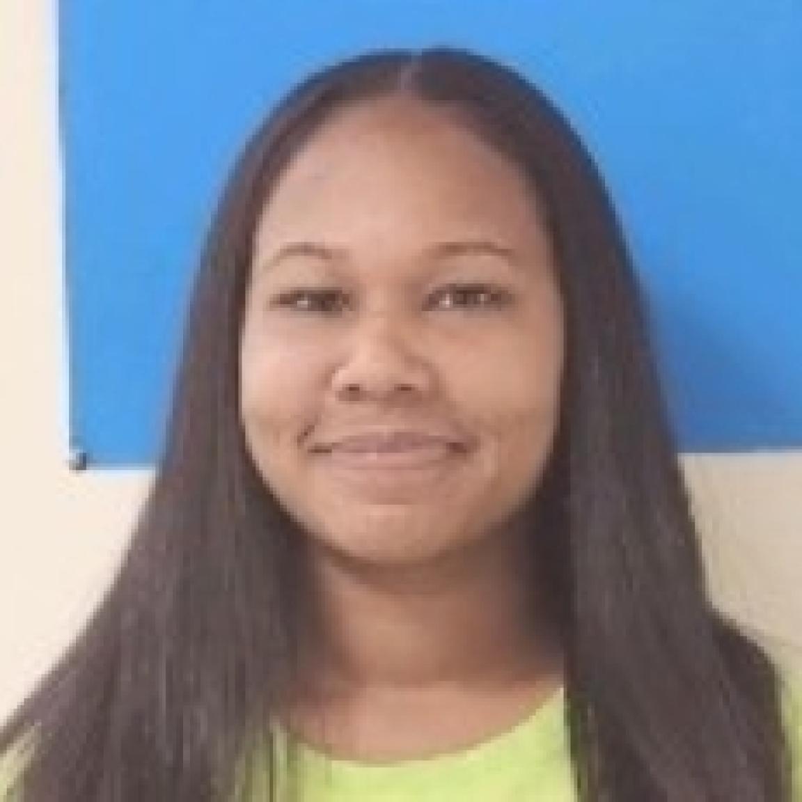young woman latino smiling with yellow shirt mugshot