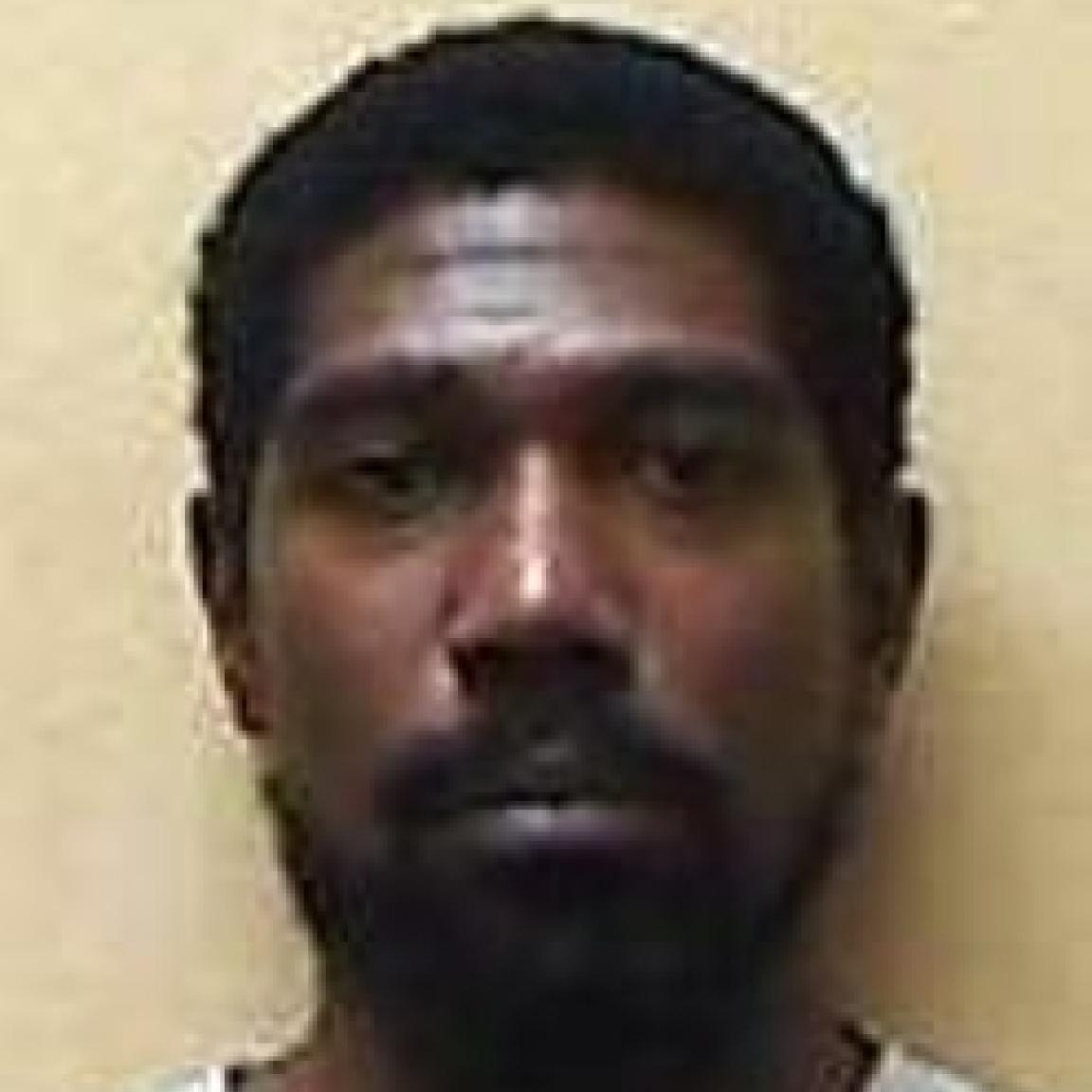 black man middle aged dark eyes mugshot