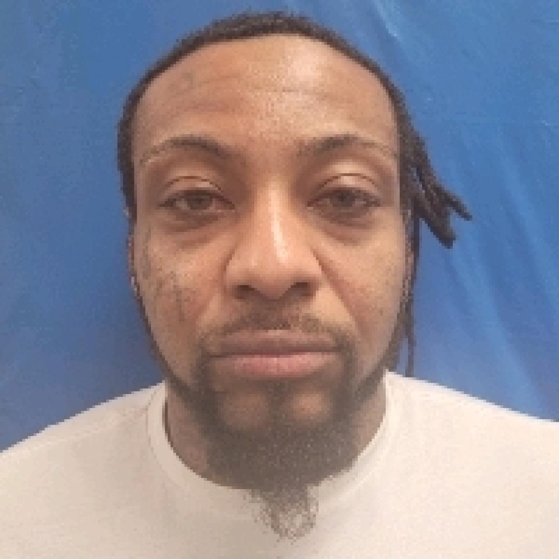 black man with mustache and scraggly beard