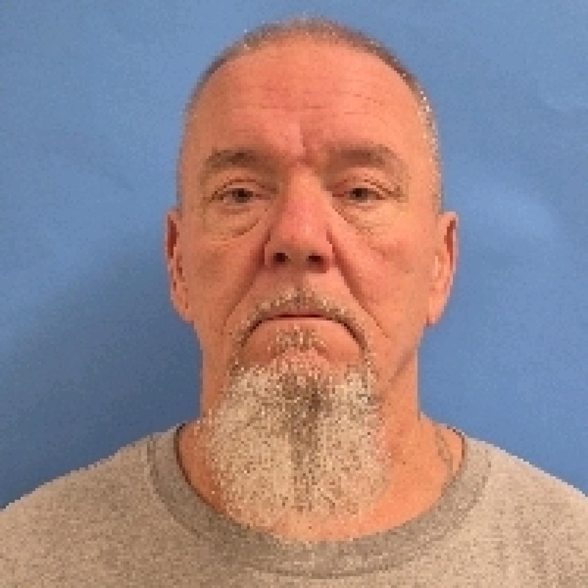 White man older with wrinkles buzz cut and long white beard
