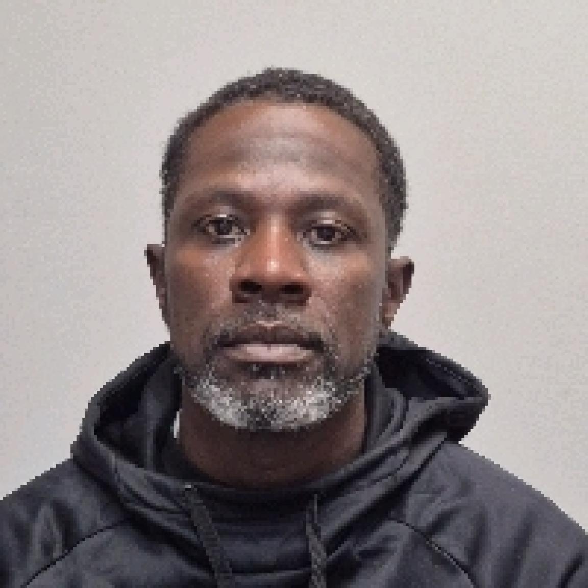 Black man short hair short white beard and block hoodie