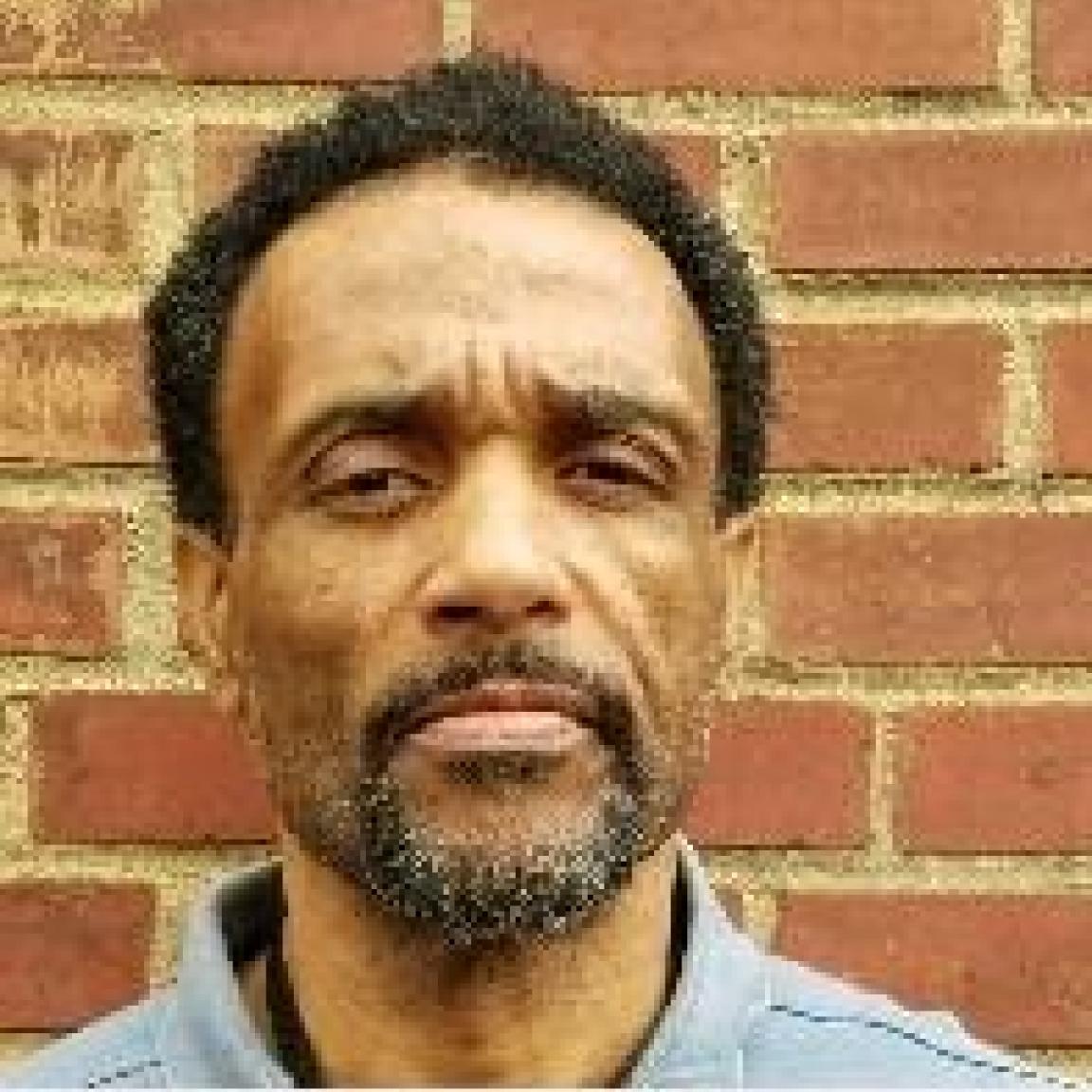 black man with grey beard and mustache