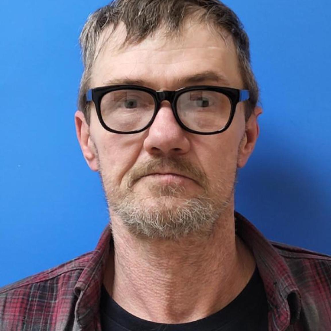 older white man with glasses beard and mustache of greying hair