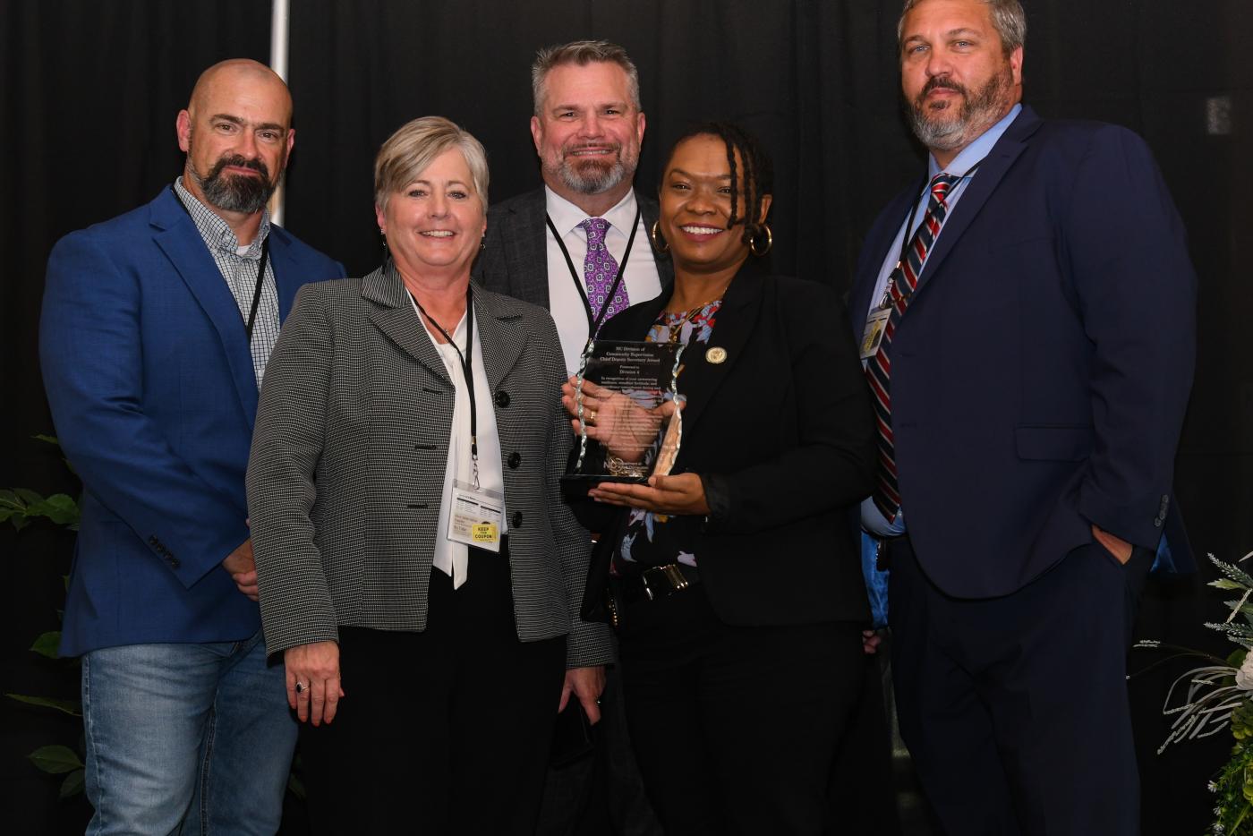 Division 4 leaders accepting Chief Deputy Secretary's award from Community Supervision leaders. 