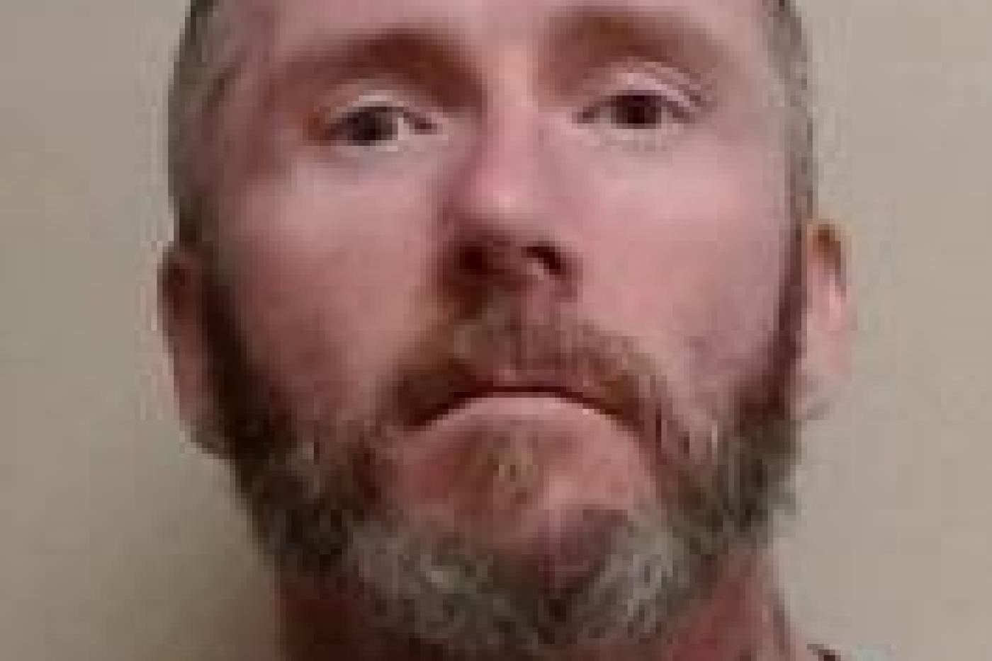 Roy Burgess - escaped inmate with tattoo on neck