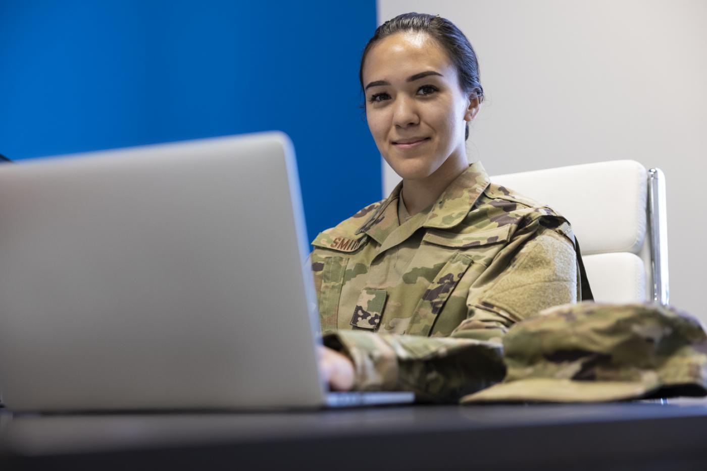 HR Events Recruitment Military- Female Seated with Computer