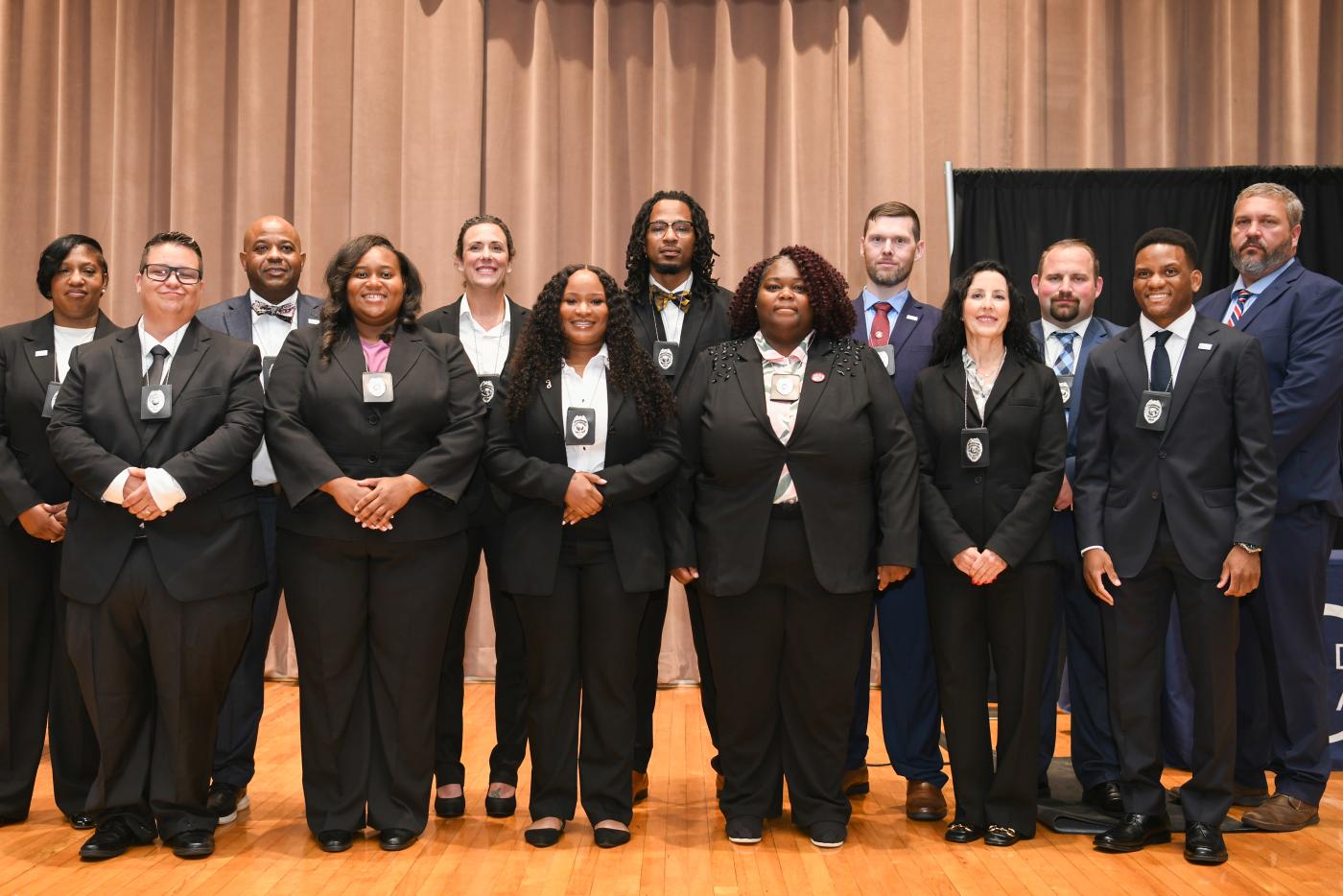 Group photo of 12 new officers from Class 6
