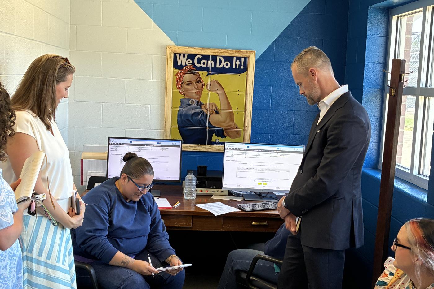 NCDAC Secretary Leslie Cooley Dismukes, N.C. Commerce Secretary Lee Lilley speak with an offender at NCCIW Addresses the NC Joint Reentry Council