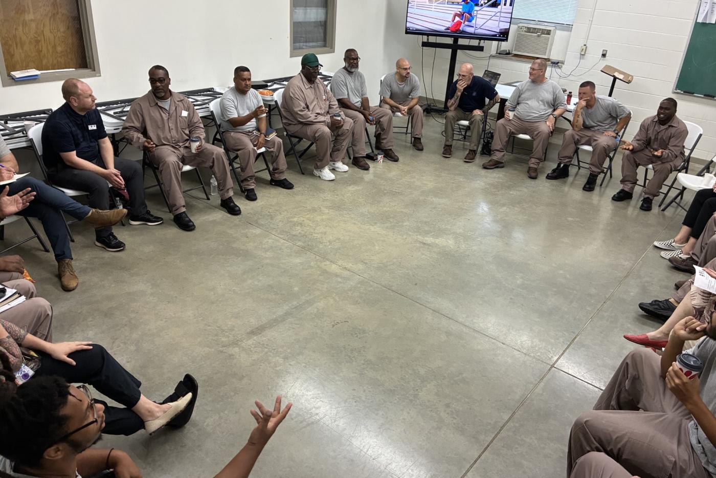 Students seated in a square during the restorative justice class