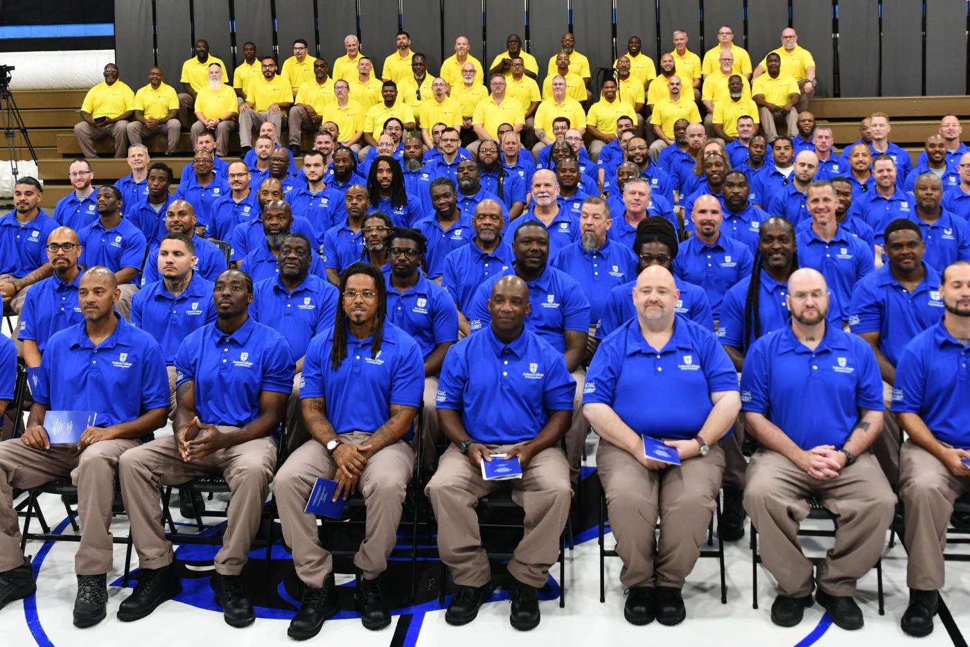 NC Field Minister men dressed in yellow and blue shirts at Nash CI