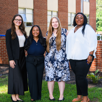 four women standing outside
