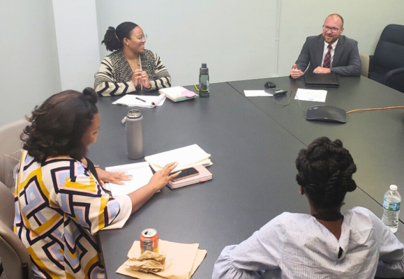 group of interns at table talking