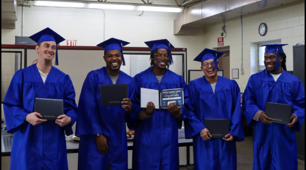 Men wearing cap and gowns at high school graduation