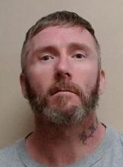 Roy Burgess - escaped inmate with tattoo on neck
