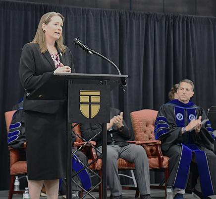 NCDAC Sec. Leslie Cooley Dismukes speaks at the convocation with SEBTS President Scott Pace clapping