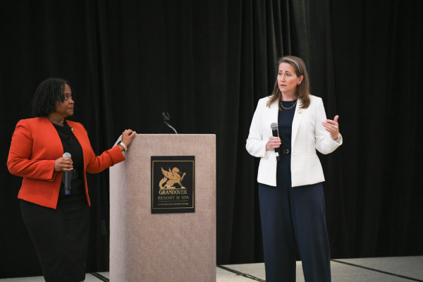 two women at podium speaking