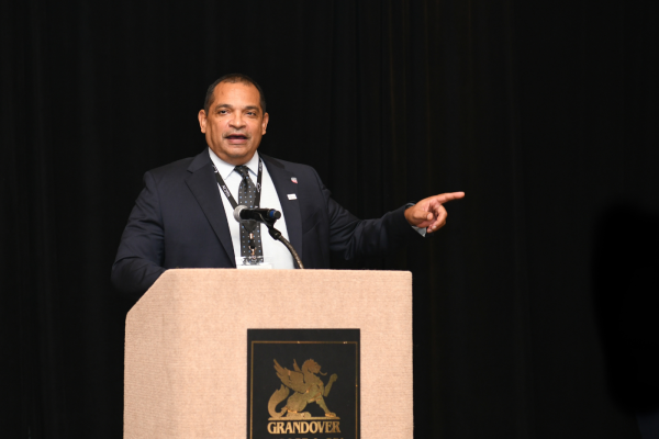 Man at podium pointing