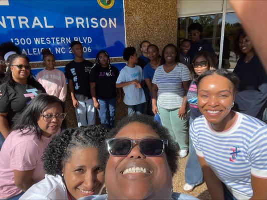 Teens and adult chaperones from Jack and Jill of America pose for a group photo outside Central Prison in Raleigh, North Carolina.