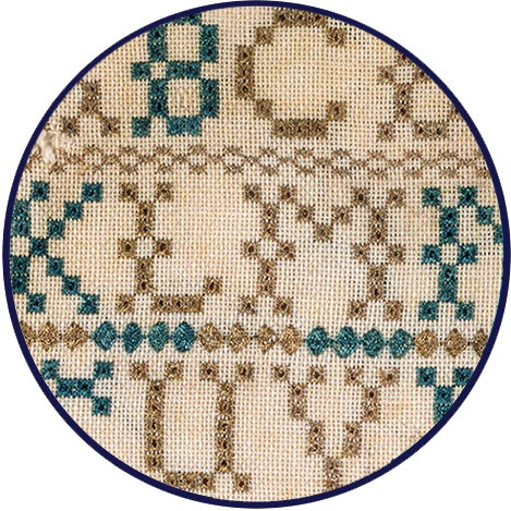 This needlework sampler includes stitched alphabets, a religious verse, and decorative motifs.