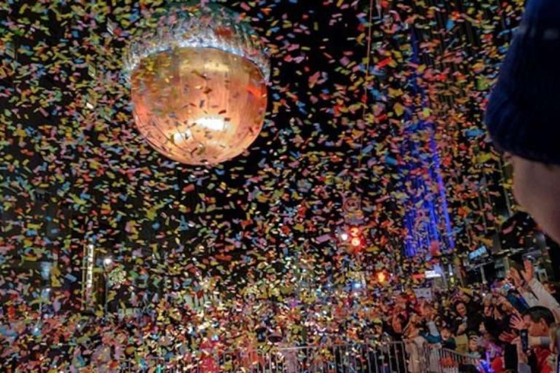Acorn sculpture made of copper is surrounded by confetti.