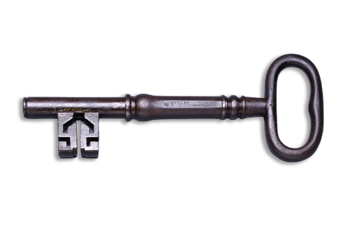 An antique metal key lying horizontally.