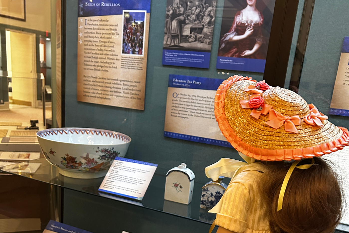 Felicity doll viewing a museum display about colonial tea customs.
