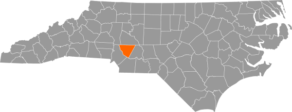 A gray map of North Carolina with Cabbarrus County filled in with orange.