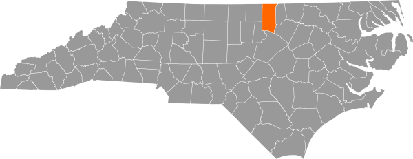 A gray map of North Carolina with Granville County filled in with orange.
