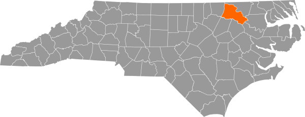 A gray map of North Carolina with Halifax County filled in with orange.