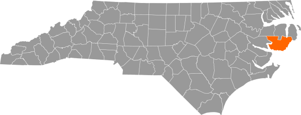 A gray map of North Carolina with Hyde County filled in with orange.