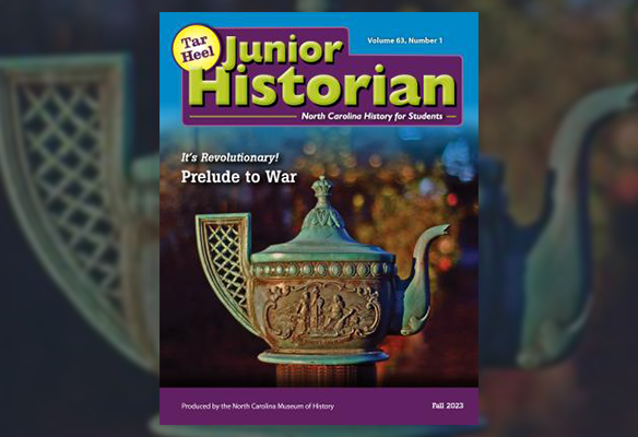 A cover image for the "Tar Heel Junior Historian" magazine, Fall 2023 issue (Volume 63, Number 1), produced by the North Carolina Museum of History. The main photograph features an intricately carved, antique patinated copper teapot with historical relief figures. The upper title text is large and green, reading "Tar Heel Junior Historian," with the subtitle "North Carolina History for Students." The central text outlines the theme: "It’s Revolutionary! Prelude to War."