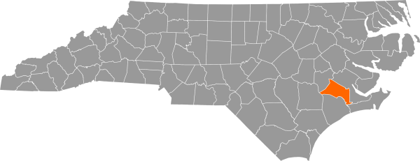 A gray map of North Carolina with Jones County filled in with orange.