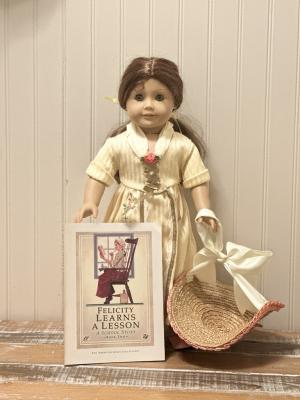 Felicity doll with Felicity Learns a Lesson book and straw hat.